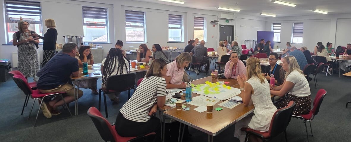 An image showing table discussion at our evaluation and learning system leadership training.