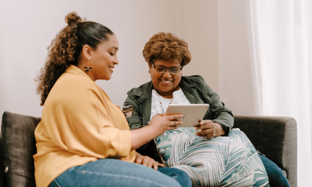 Two females looking at a tablet screen