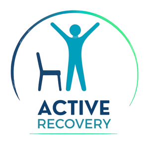 Active Recovery logo shows an icon of a person standing with their arms raised above their head, and a chair next to them. The words Active Recovery are below the icon and the chair and the logo is in the shape of a circle.